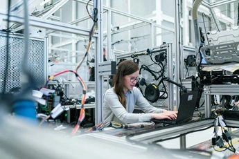 working on a computer in a technical workshop